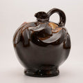 Brown ceramic bottle with floral decor